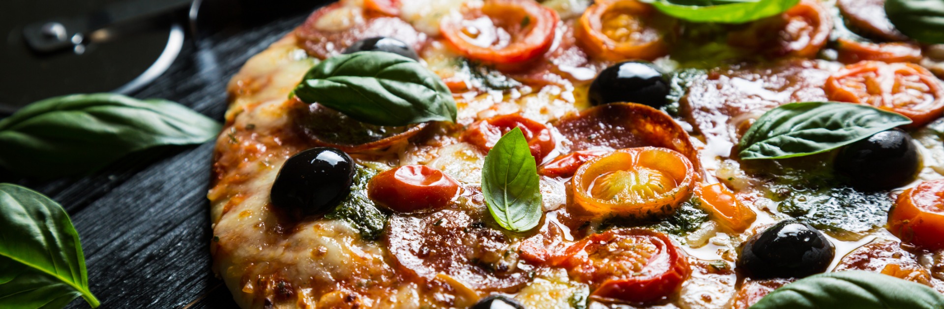 pizza with salami olives and basil picture id1354167968