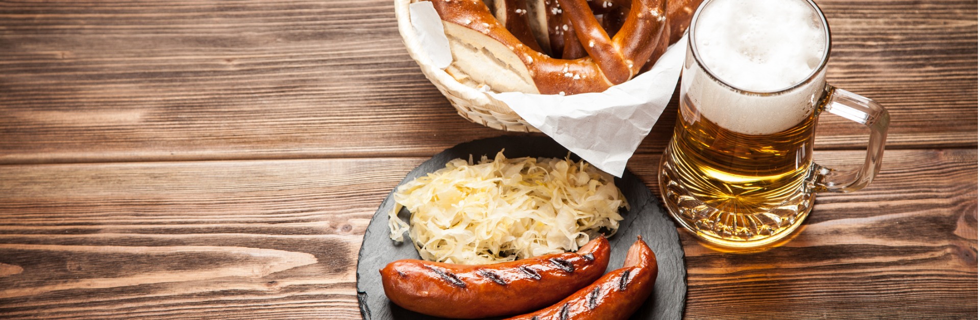 pretzels bratwurst and sauerkraut on wooden table picture id615261878