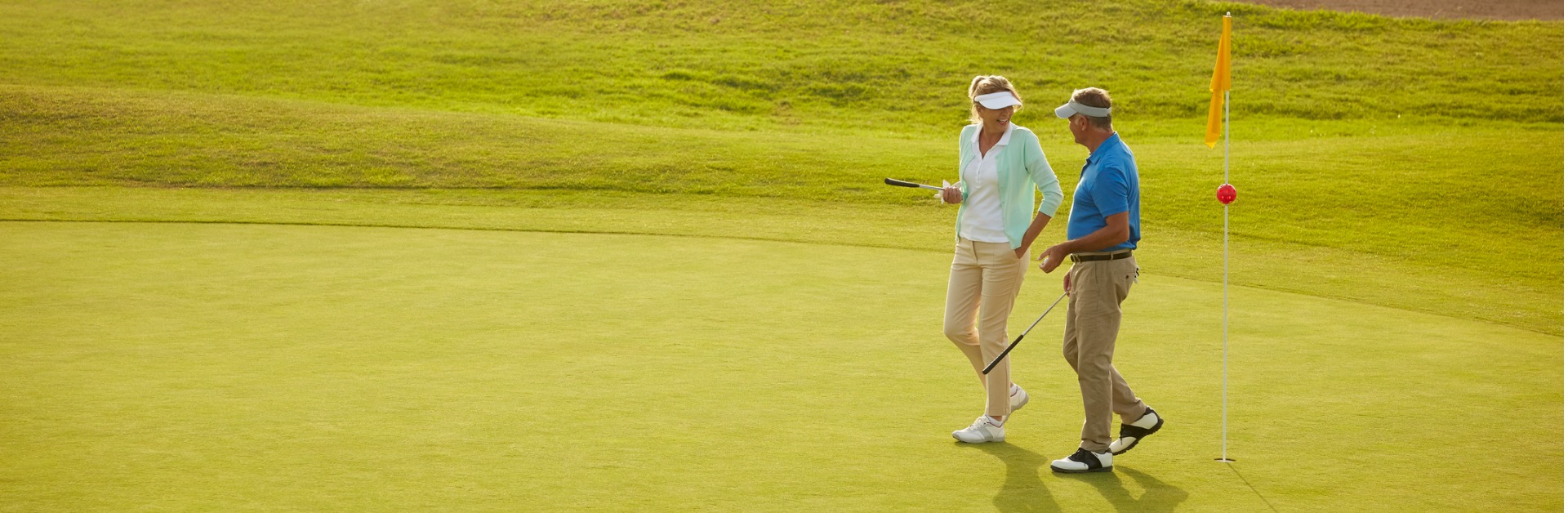 senior couple walking on golf